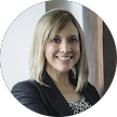 Smiling woman in a blazer, professional headshot portrait against a light background